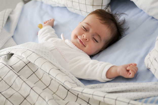 smiling-baby-lying-bed_1139-14